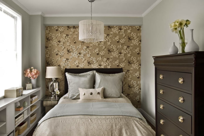 one of the walls is covered with wallpaper with a floral pattern