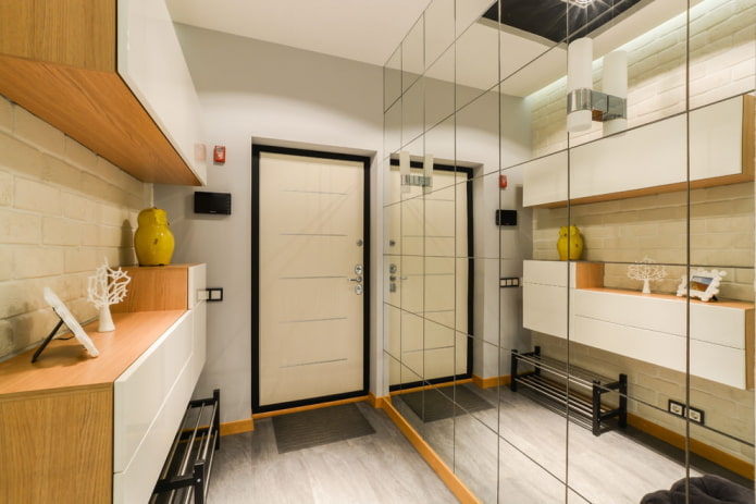 a full-wall mirror in the hallway