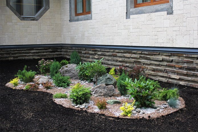 flowerbed with rocks near the house