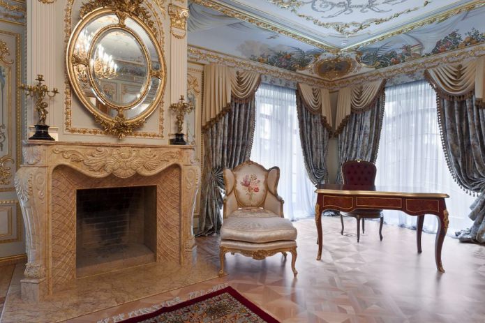 frescoes, a mirror in a gold frame, a fireplace with moldings