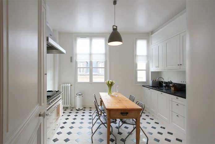 snow-white kitchen with a black countertop