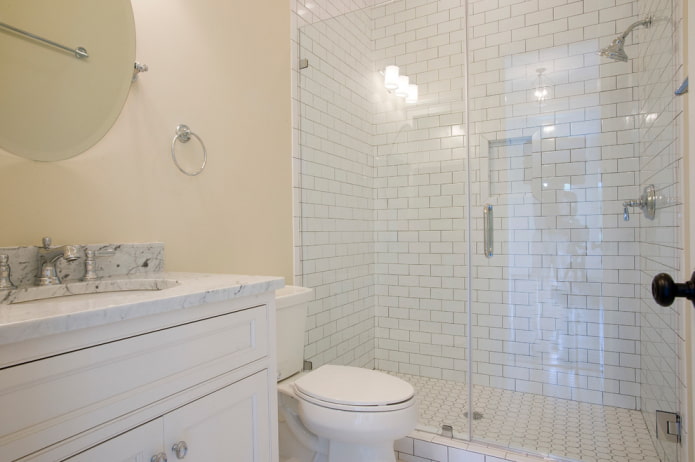 white tiles in the shower in the bathroom