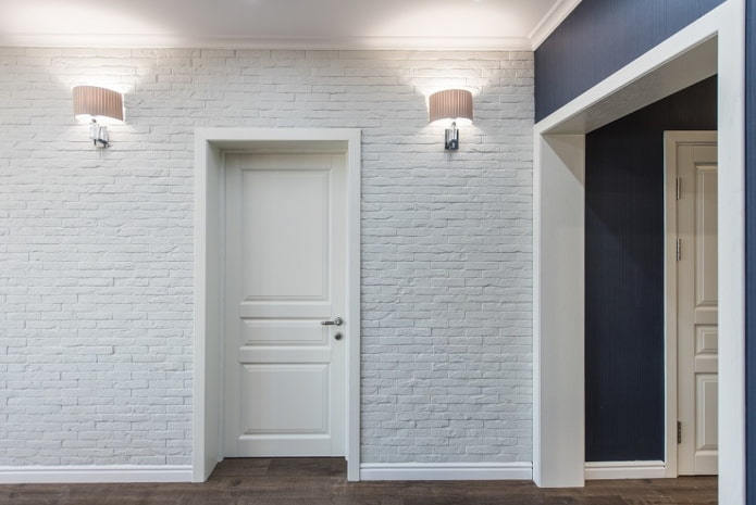 white doors with white baseboard in the interior