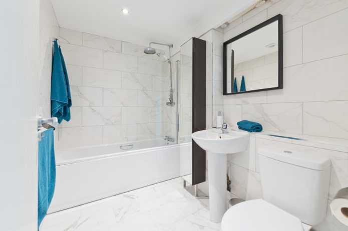white tiles on the floor in the bathroom