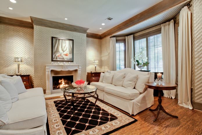 Beige wallpaper in the interior of the living room with a fireplace