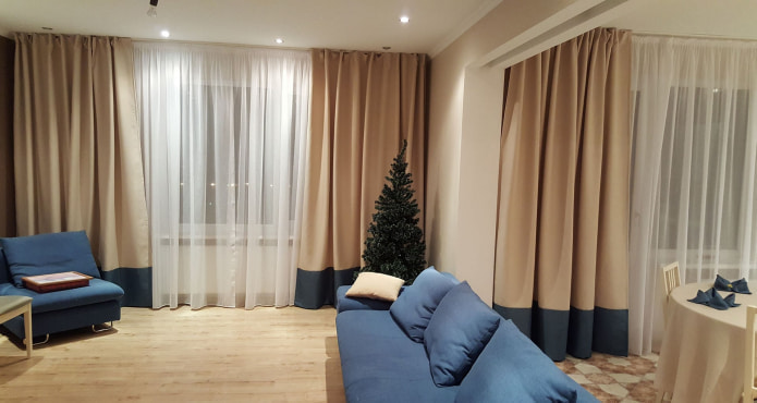 beige curtains with a dark blue bottom