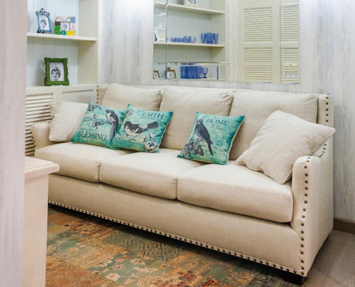 beige sofa with turquoise pillows