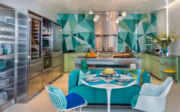 The photo shows a modern kitchen in turquoise tones