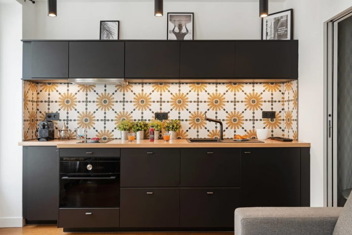 black kitchen set with a white and yellow apron