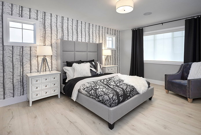 gray bed and black curtains