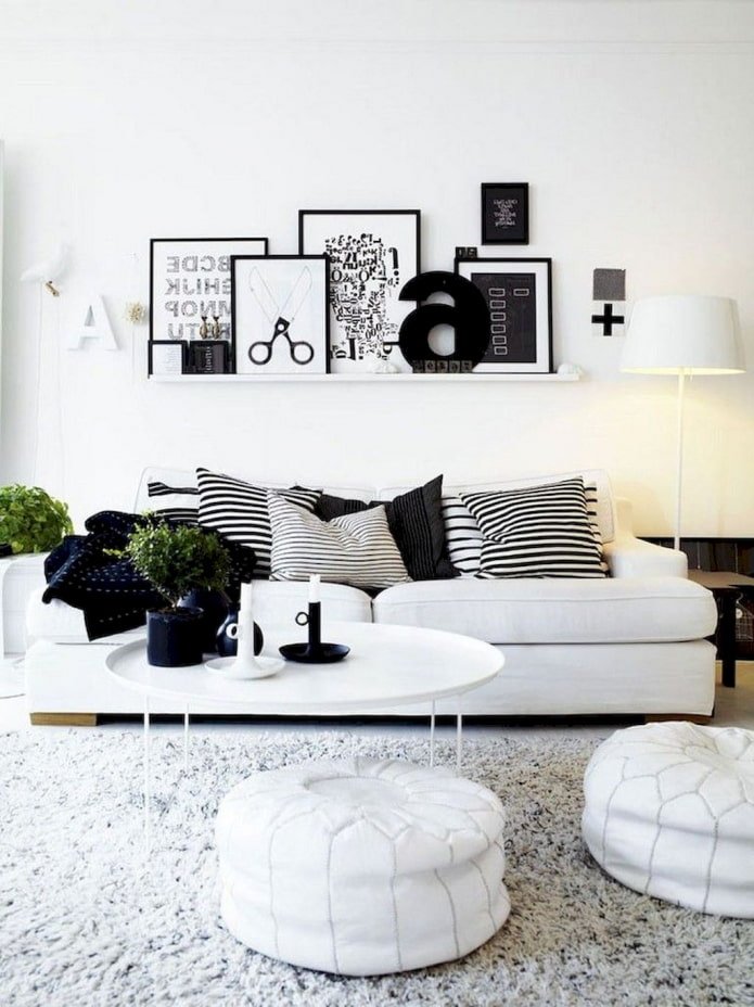 shelf with paintings above the sofa