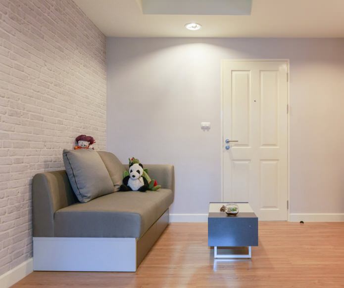 brick wallpaper in children's room interior