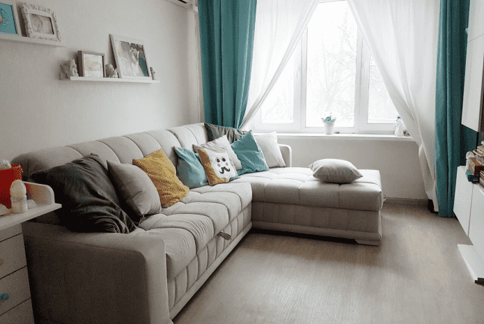sofa model with an ottoman in the children's room interior