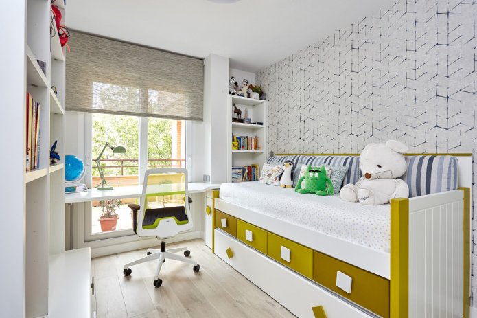 table by the window and a bed with drawers