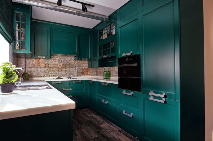 dark emerald kitchen with a mosaic apron