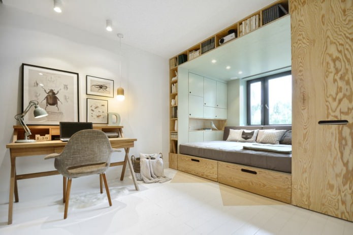 bed with built-in drawers by the window in a small nursery
