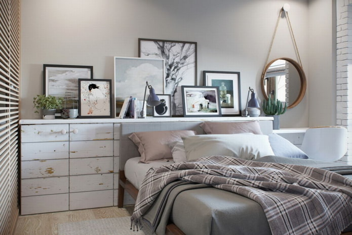 shelf with paintings above the bed