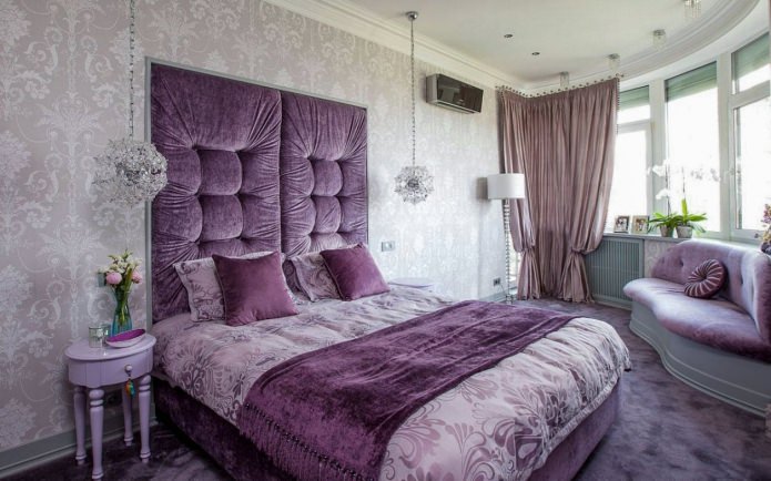 Gray-purple bedroom interior with a soft headboard