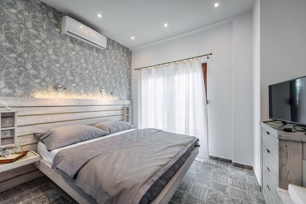 white curtains in the design of the bedroom with gray wallpaper
