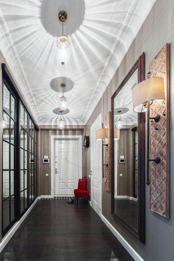 three chandeliers in a long corridor