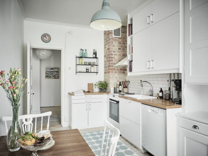 White kitchen with a brick-finished ventilation box