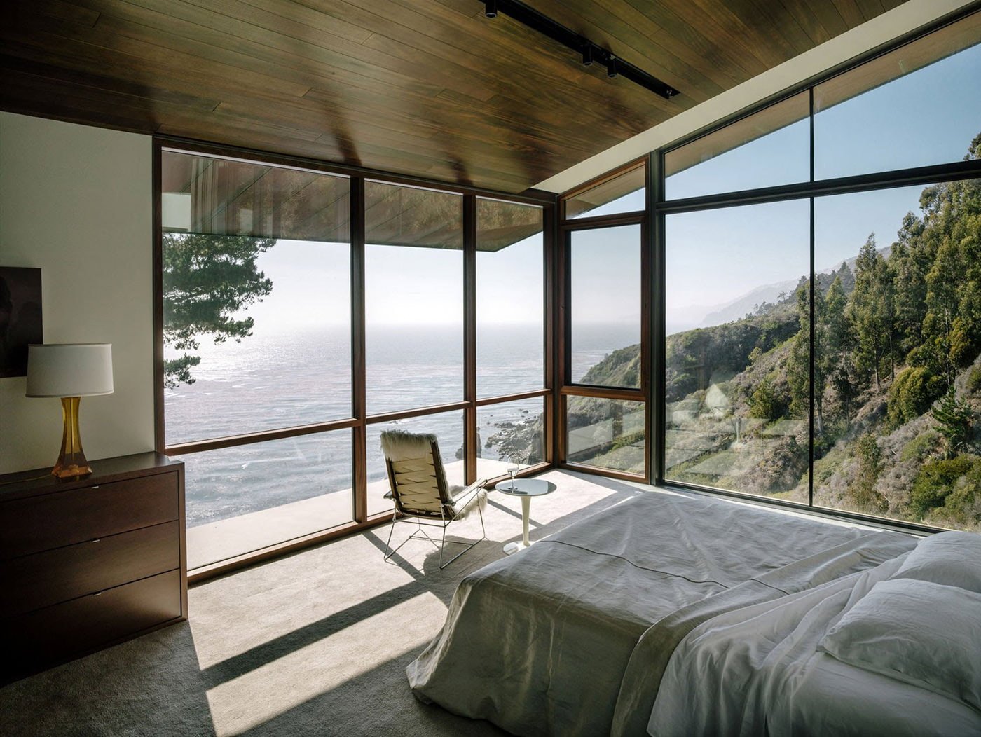 interior of the bedroom in a country house with panoramic windows