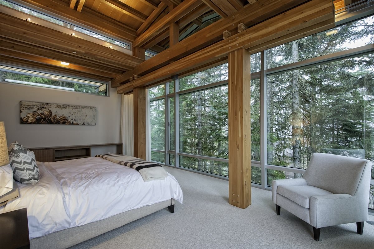 Interior of a bedroom in a country house with panoramic windows