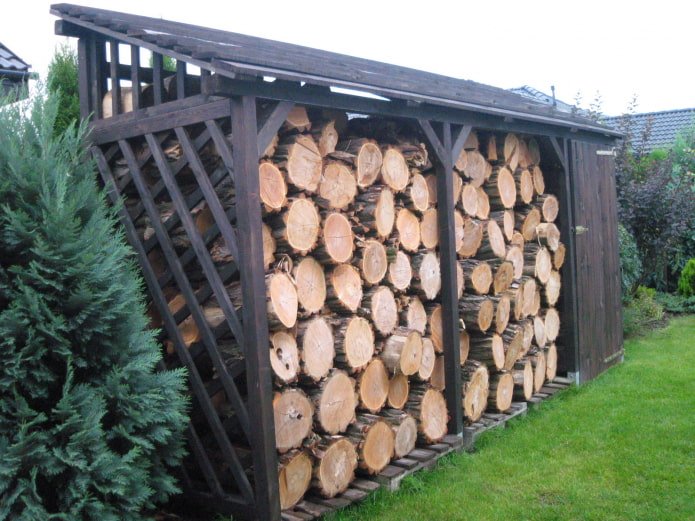 a firewood shed near a fence
