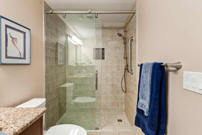 shower made of beige tiles in interior