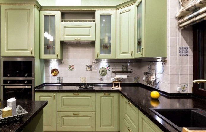 green kitchen with a black countertop