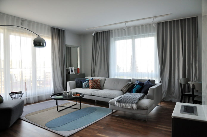 sofa in a living room with two windows