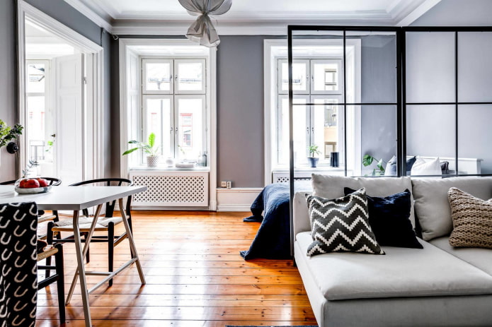zoning a living room with a bed