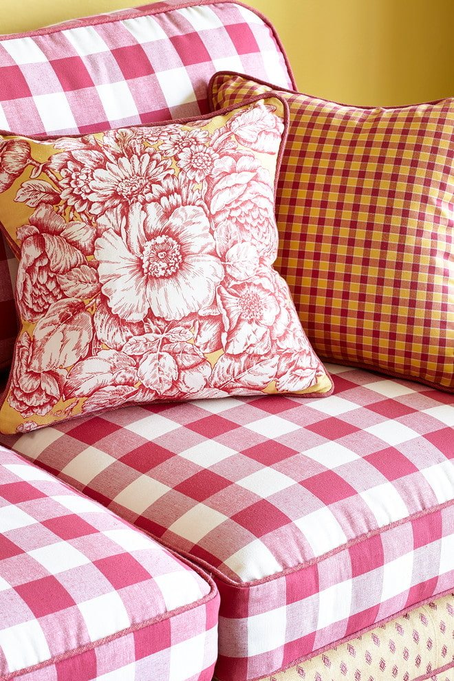 Checkered upholstery of the armchair and a floral print