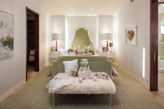 a girl's room with a green bed
