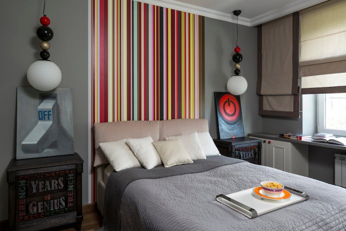 multicolored striped wall at the head of the bed