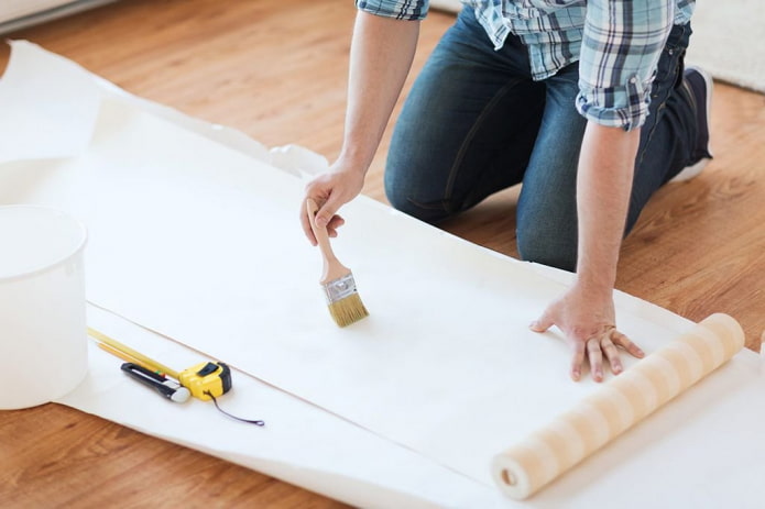 wallpaper pasting, applying glue with a brush
