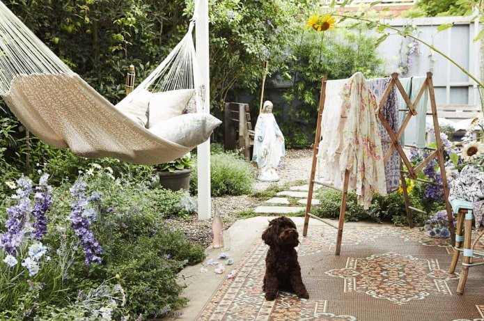 hammock attached to white wooden poles in boho style