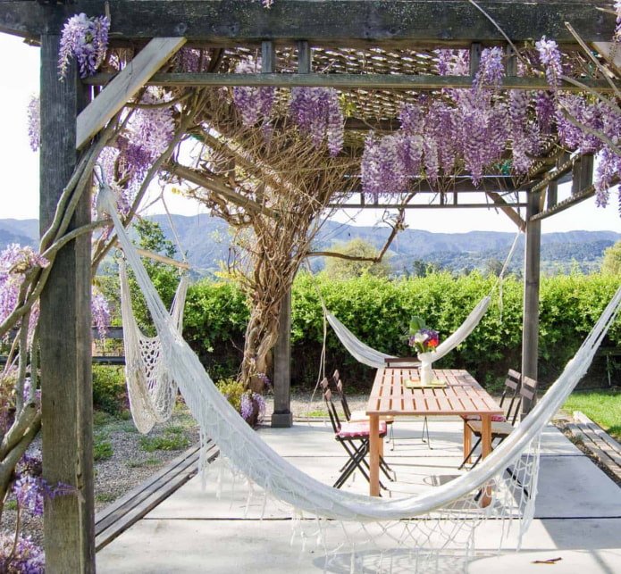 3 hammocks around the perimeter of the pergola