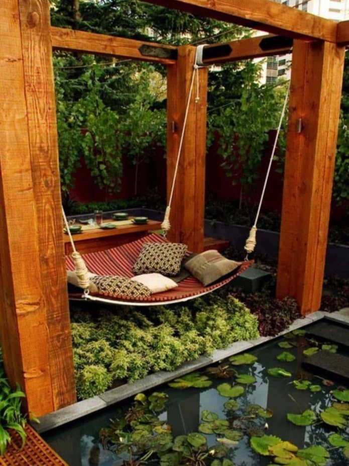 stylish hammock for several people is supported by 4 poles