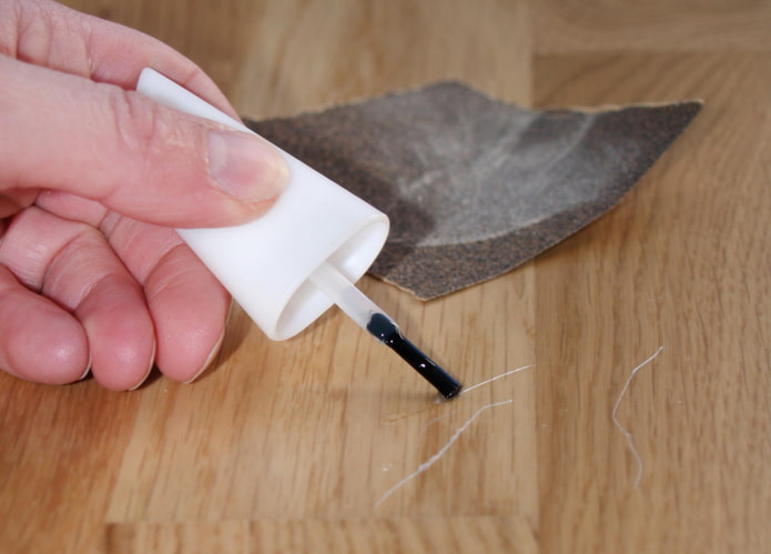 Nail polish against floor scratches