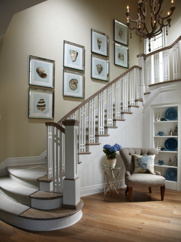 paintings along the stairs in the hallway