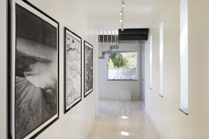 black and white paintings in the interior of the hallway