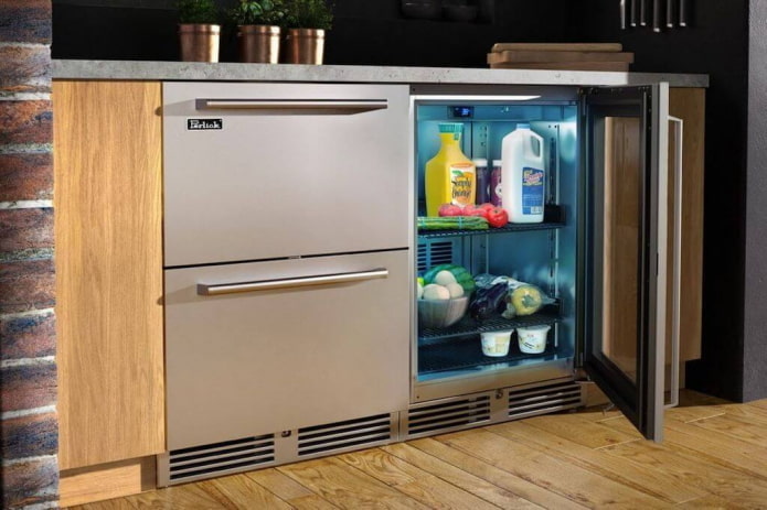 refrigerator under the countertop in the kitchen interior
