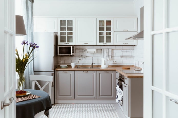 refrigerator next to the sink in the kitchen interior