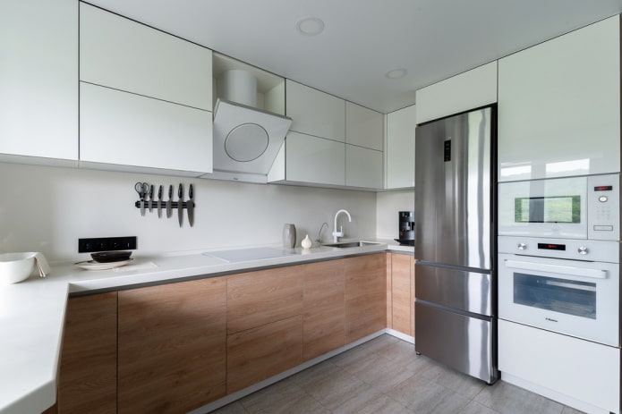 refrigerator next to the sink in the kitchen interior