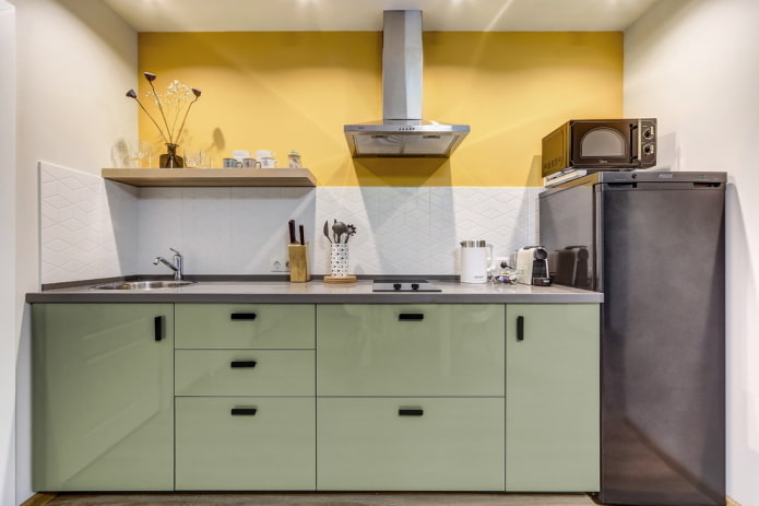 refrigerator in the interior of a linear kitchen