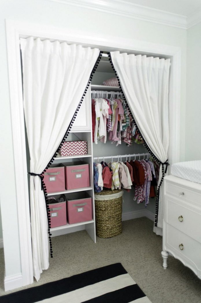niche with clothes behind a curtain