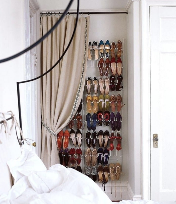 niche with clothes behind a curtain
