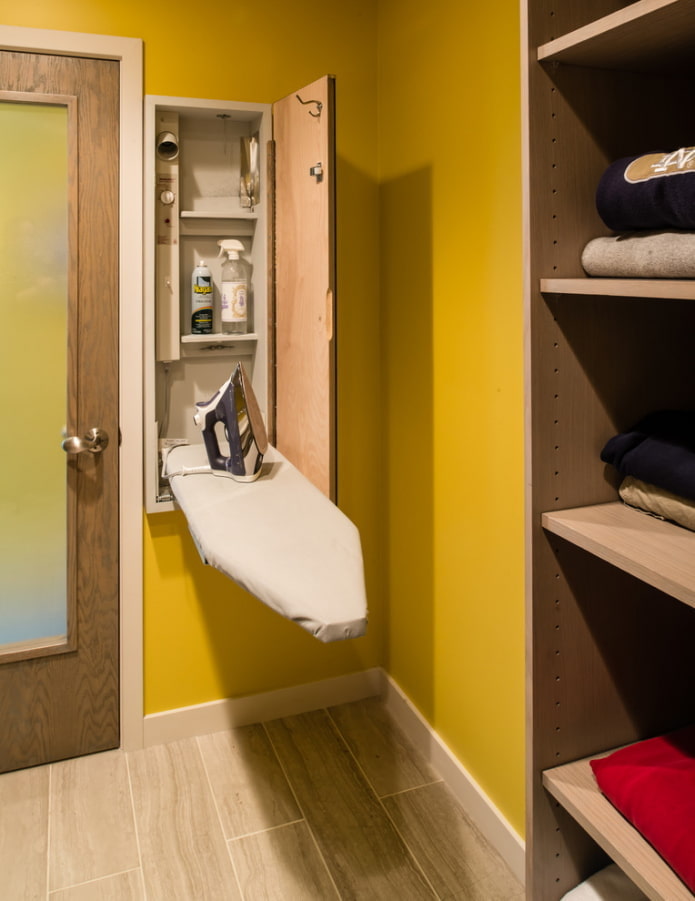Wall cabinet for an ironing board
