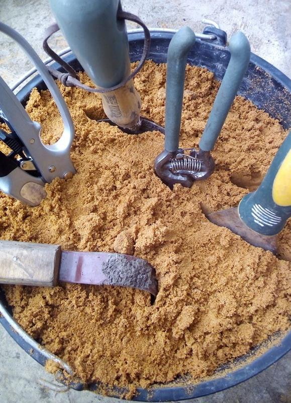 Tools in a bucket with sand